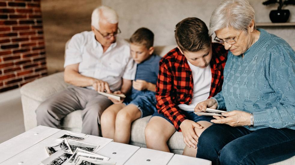 grandparents and children looking at photos